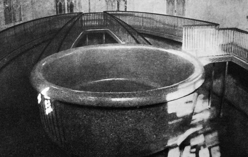 Historische Schwarzweißaufnahme: die Granitwanne im noch intakten Saal mit Geländer